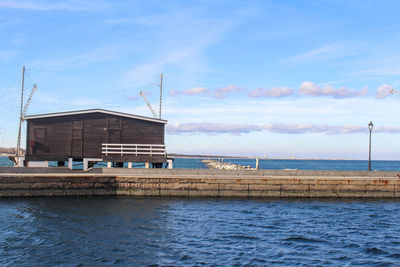 Building by sea against sky