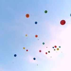 Low angle view of balloons against sky