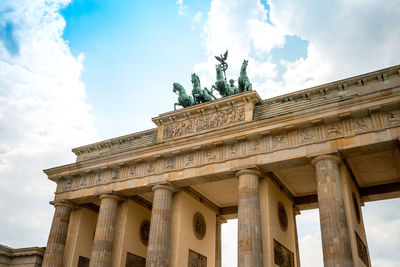 Low angle view of quadriga on brandenburg gate against sky