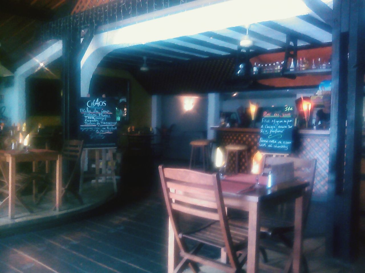 indoors, illuminated, absence, table, in a row, no people, empty, selective focus, architecture, chair, technology, modern, built structure, night, reflection, lighting equipment, restaurant, large group of objects, arrangement, incidental people