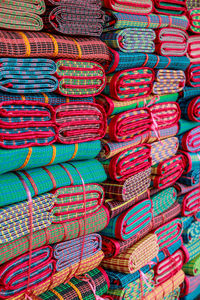 Full frame shot of multi colored folded mats for sale at market stall