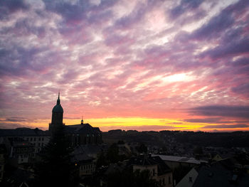 View of cityscape against cloudy sky