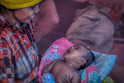 A mother is singing to her baby