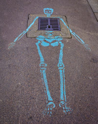 High angle view of arrow sign on road in city