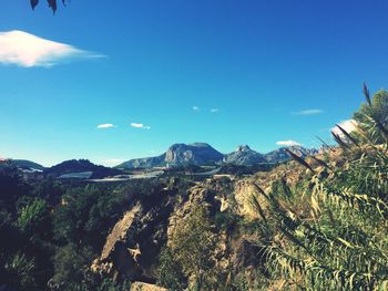 Scenic view of landscape against blue sky