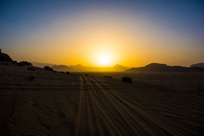 Scenic view of desert against sky during sunset