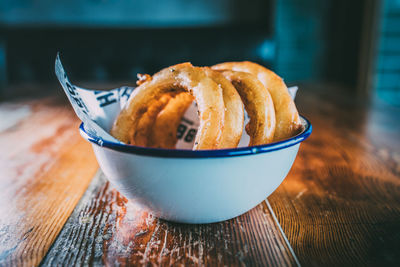 Close-up of onion rings in bowl on table