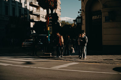 People walking on road in city