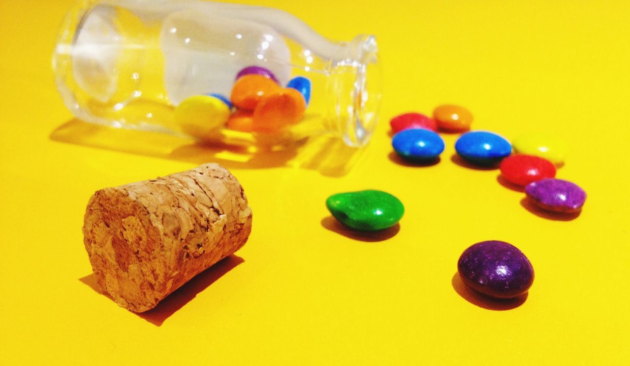 indoors, still life, studio shot, sweet food, multi colored, close-up, art and craft, table, food, creativity, white background, food and drink, variation, unhealthy eating, indulgence, candy, dessert, large group of objects, art, yellow