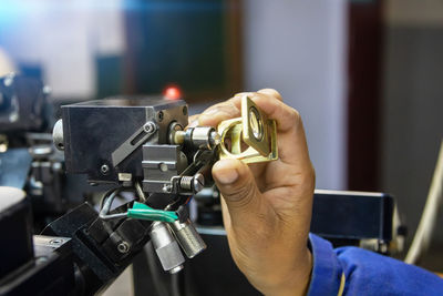 Close-up of hands working in factory