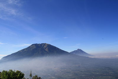 View of volcanic mountain range against blue sky