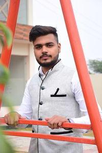 Portrait of young man standing outdoors