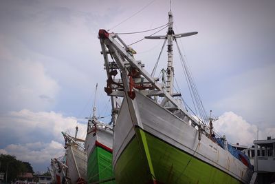 Low angle view of ship moored at harbor against sky