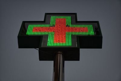 Close-up of illuminated lamp against sky