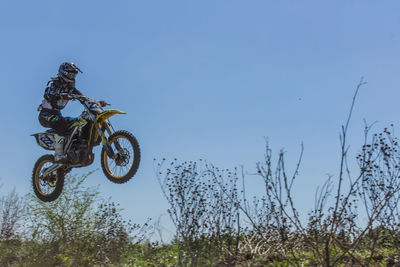 Man riding bicycle against sky