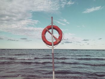 Lifeguard hut on sea against sky