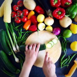 Low section of woman holding vegetables