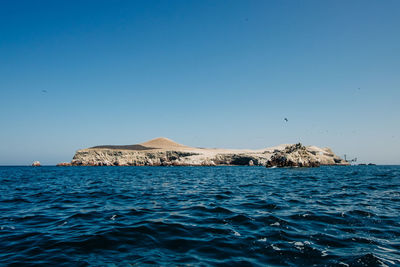 Scenic view of sea against clear blue sky