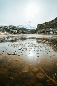 Scenic view of lake against sky during winter