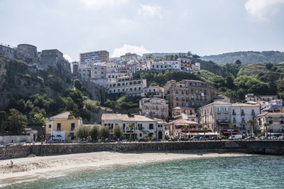 Town by sea against sky