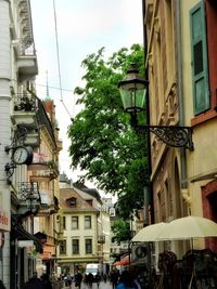 People on street amidst buildings in city