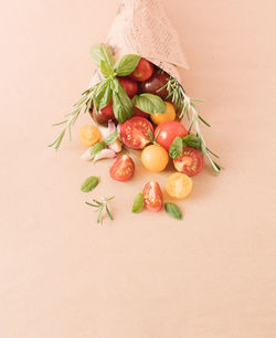 Cherry tomatoes and spices in a paper bag. minimal food concept. close up. copy space.