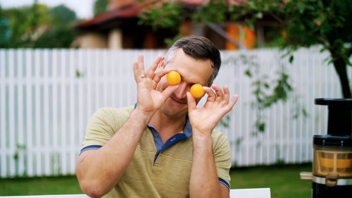 Summer, in the garden. a man, father, having fun with his family outdoors, twisting, applying