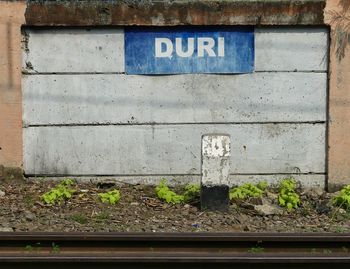 Close-up of text on brick wall