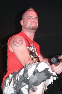 Portrait of man looking away while standing against black background