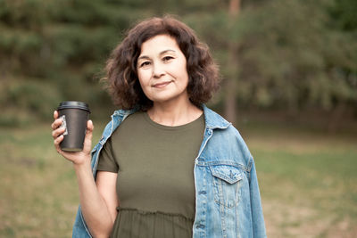 Portrait of smiling woman standing outdoors