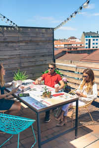 Group of friends having a drink on a terrace