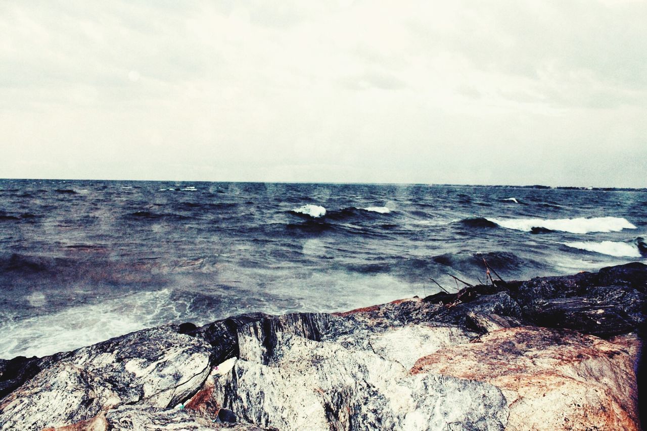 sea, horizon over water, water, beach, wave, scenics, beauty in nature, sky, shore, surf, tranquil scene, tranquility, rock - object, nature, idyllic, rock formation, cloud - sky, coastline, motion, remote