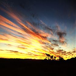 Silhouette of landscape against dramatic sky