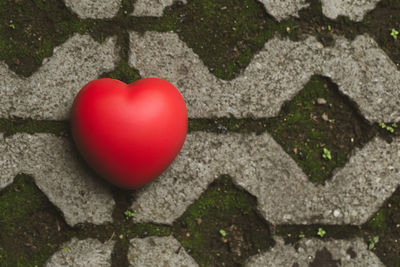 High angle view of heart shape on stone wall