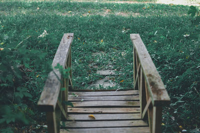 High angle view of empty bench on field