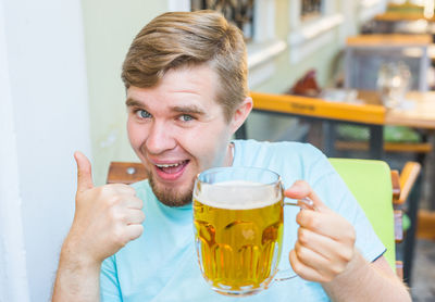Portrait of man drinking beer glass