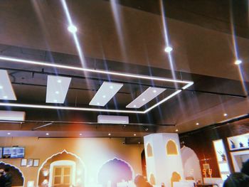 Low angle view of illuminated lights hanging from ceiling