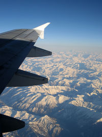 Cropped image of airplane wing over landscape