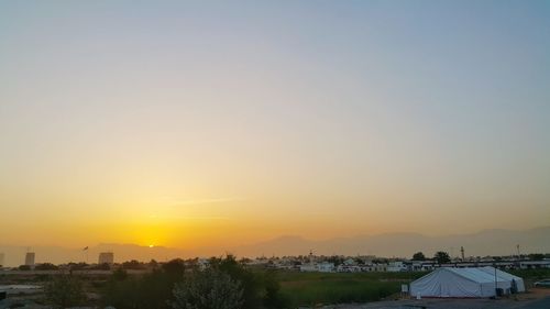 Scenic view of buildings against sky during sunset