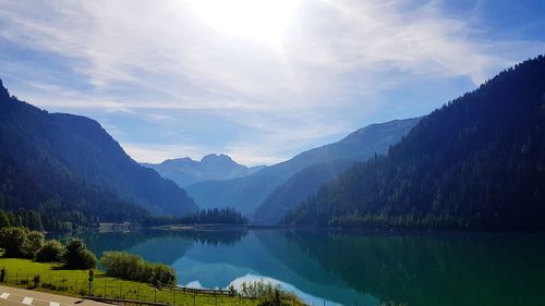 Scenic view of lake and mountains against sky