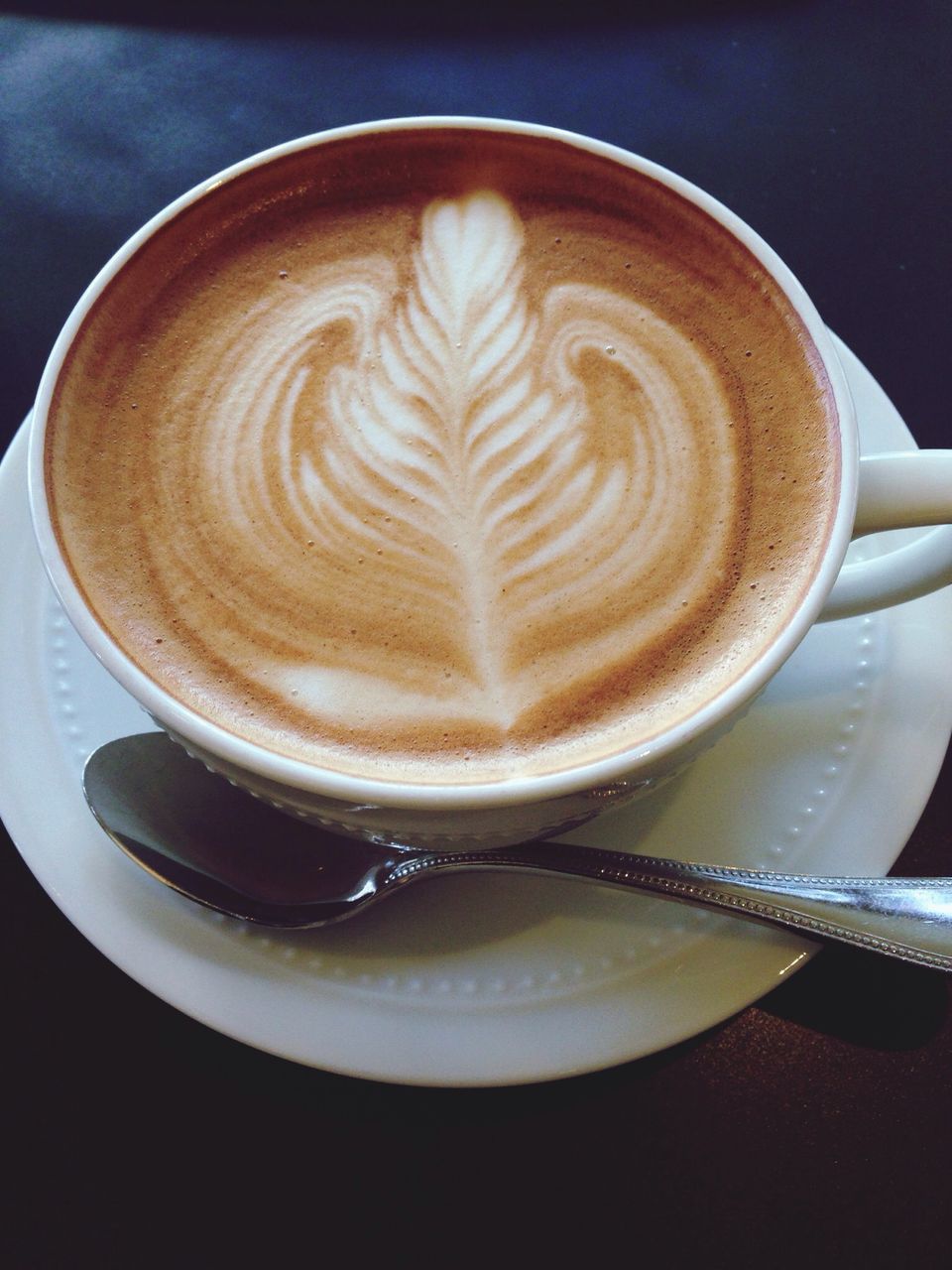 coffee cup, froth art, coffee - drink, drink, refreshment, cappuccino, frothy drink, saucer, food and drink, indoors, close-up, table, coffee, latte, still life, art, creativity, design, freshness, heart shape