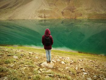 Rear view of woman walking on water