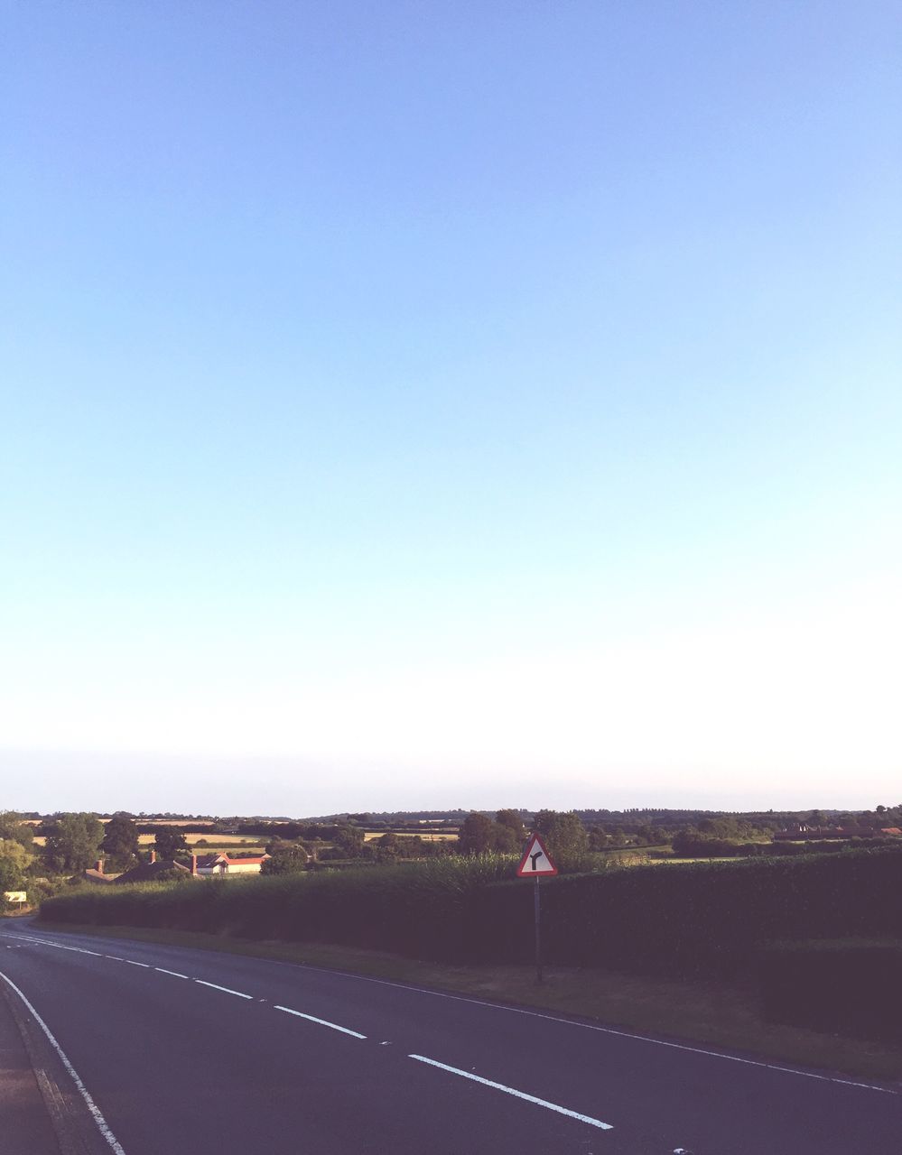 road, clear sky, copy space, road marking, transportation, landscape, blue, the way forward, empty, country road, solitude, dividing line, street, tranquil scene, tranquility, day, double yellow line, countryside, outdoors, long, empty road, scenics, nature, vanishing point, horizon over land, white line, diminishing perspective, remote, non-urban scene, wide shot