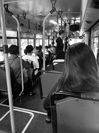 Rear view of people sitting in train