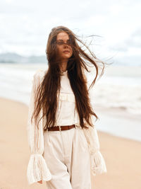 Young woman standing at beach