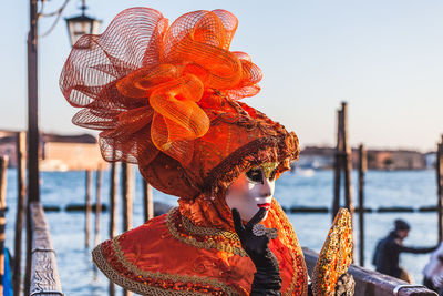 Portrait of woman standing by sea against sky