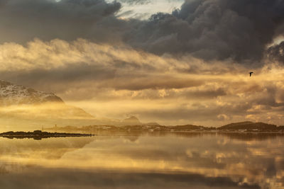 Scenic view of lake against sky during sunset