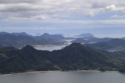 Scenic view of mountains against cloudy sky