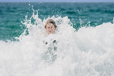 Portrait of boy swimming in pool
