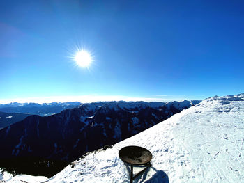 Scenic view of snowcapped mountains against clear blue sky